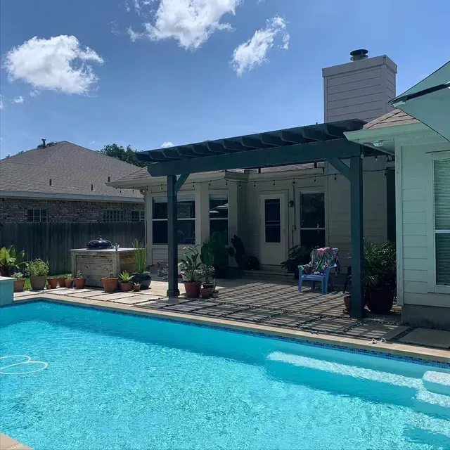 A house with a swimming pool in front of it