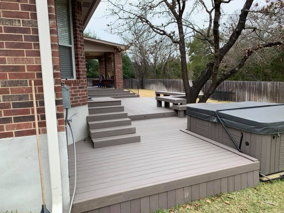 There is a hot tub on the deck of a house.