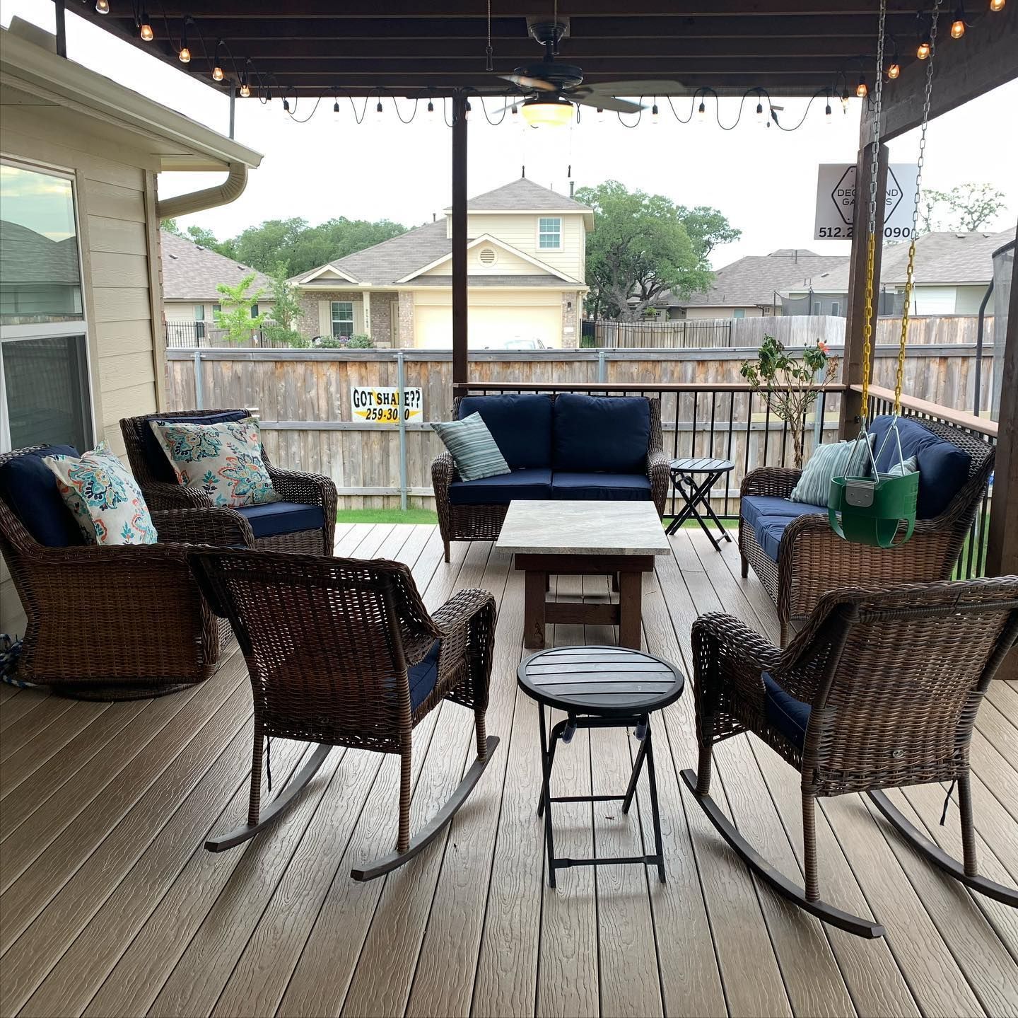 A deck with rocking chairs , a couch , and a table.