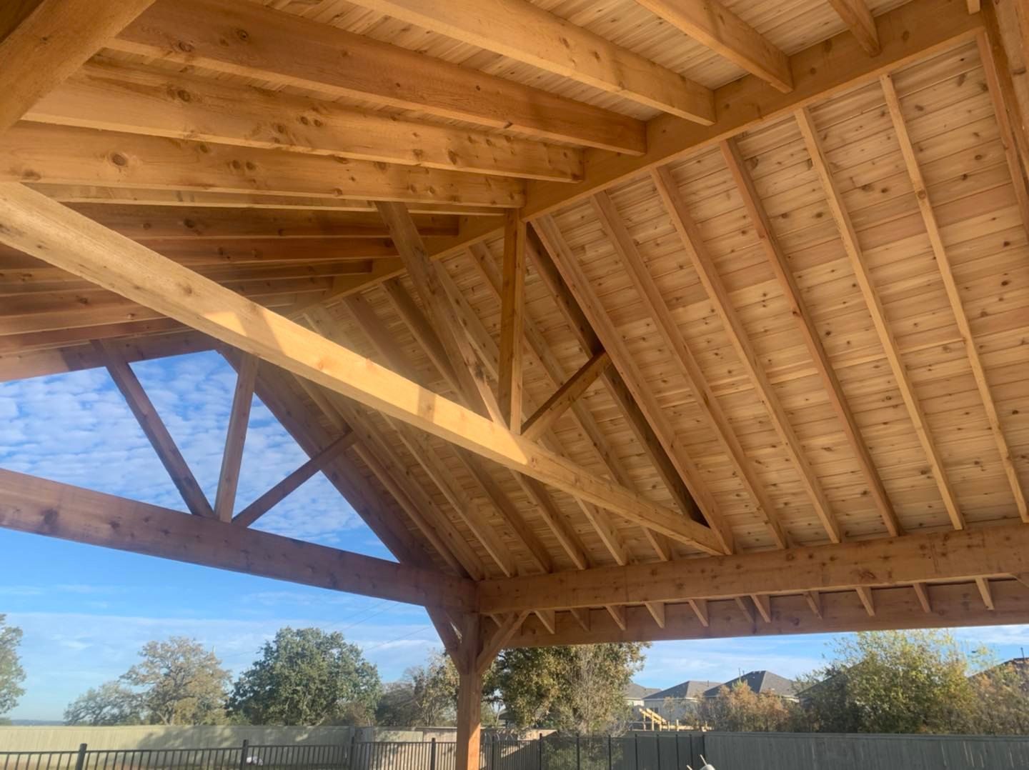 The roof of a wooden structure is being built.