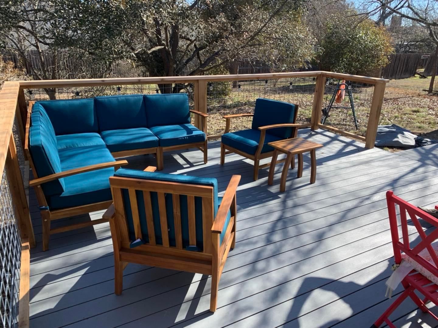 A deck with a couch and chairs on it