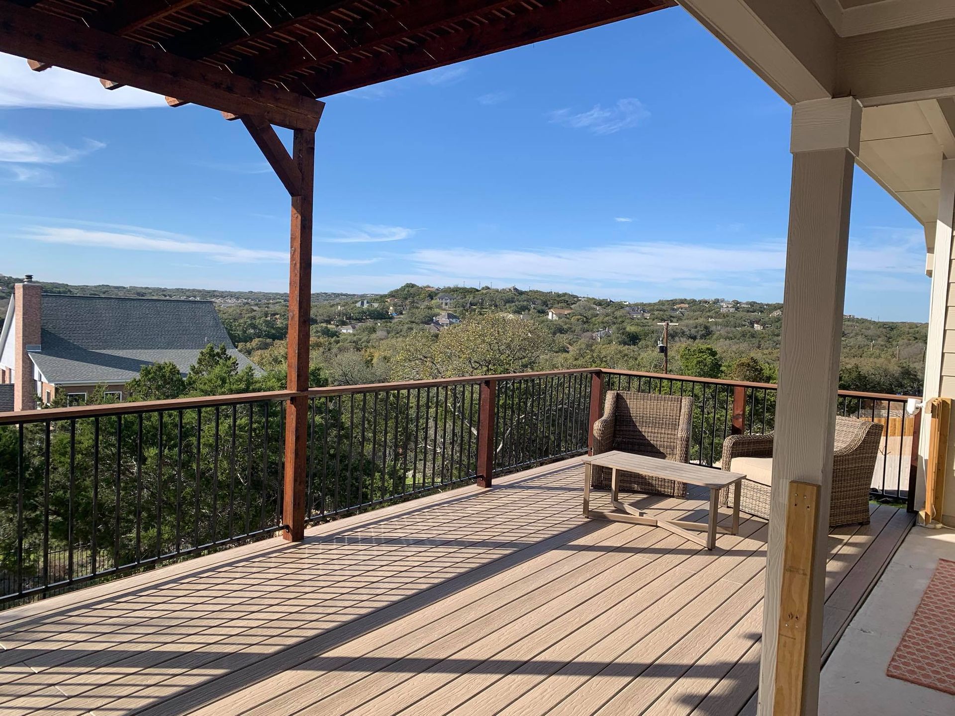 A large deck with a view of a forest and mountains