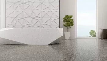 Modern white office interior with geometric wall, white desk, potted plant, and doorway with natural light