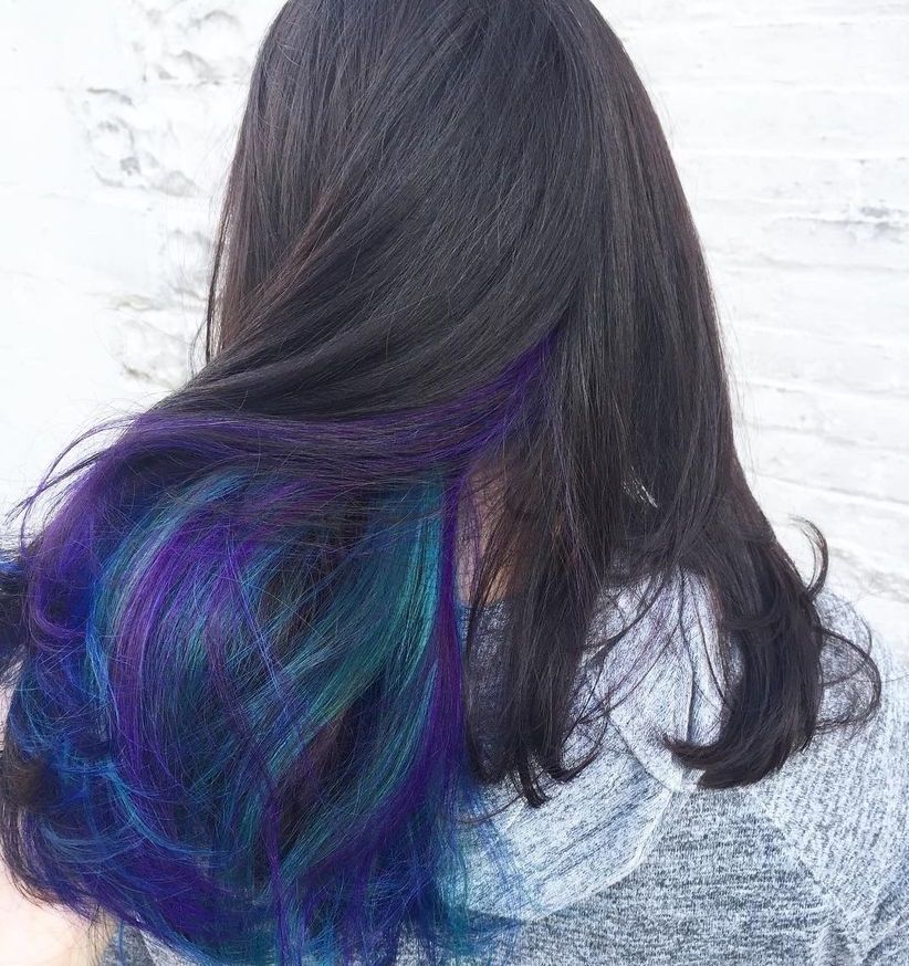 a woman with black hair with blue and purple highlights