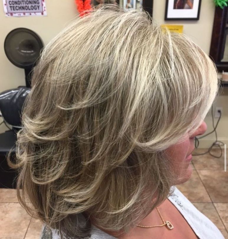 a woman is getting her hair done in a salon