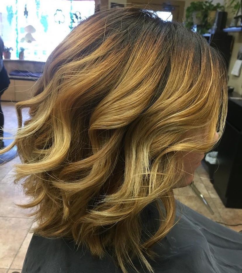 a woman is getting her hair cut in a salon