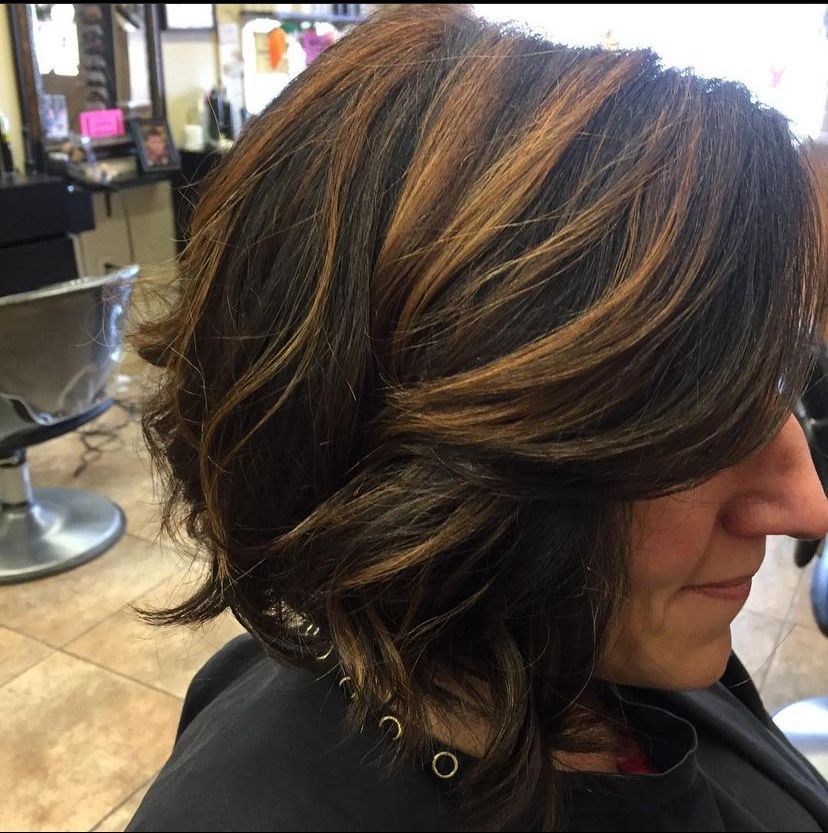 a woman is getting her hair cut in a salon