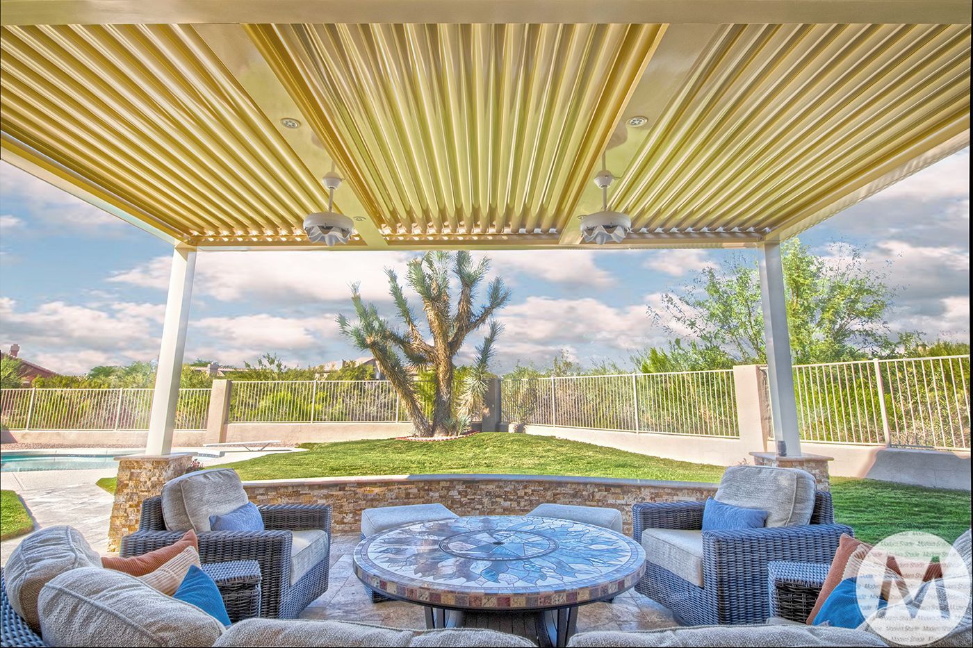 Outdoor seating area under a beige pergola with a view of a tree and a swimming pool.