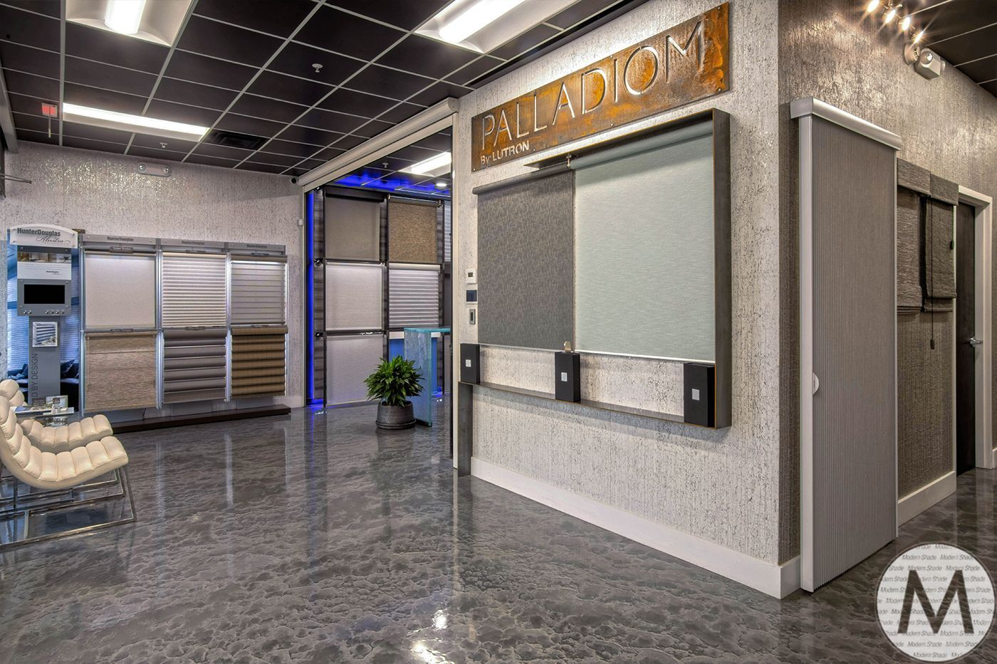 Interior showroom with flooring and wall samples, reflective floor.