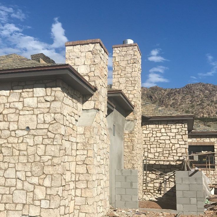 A stone building with chimneys on top of it