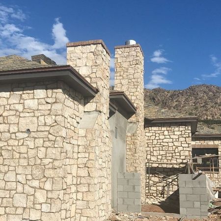 A stone building with chimneys on top of it