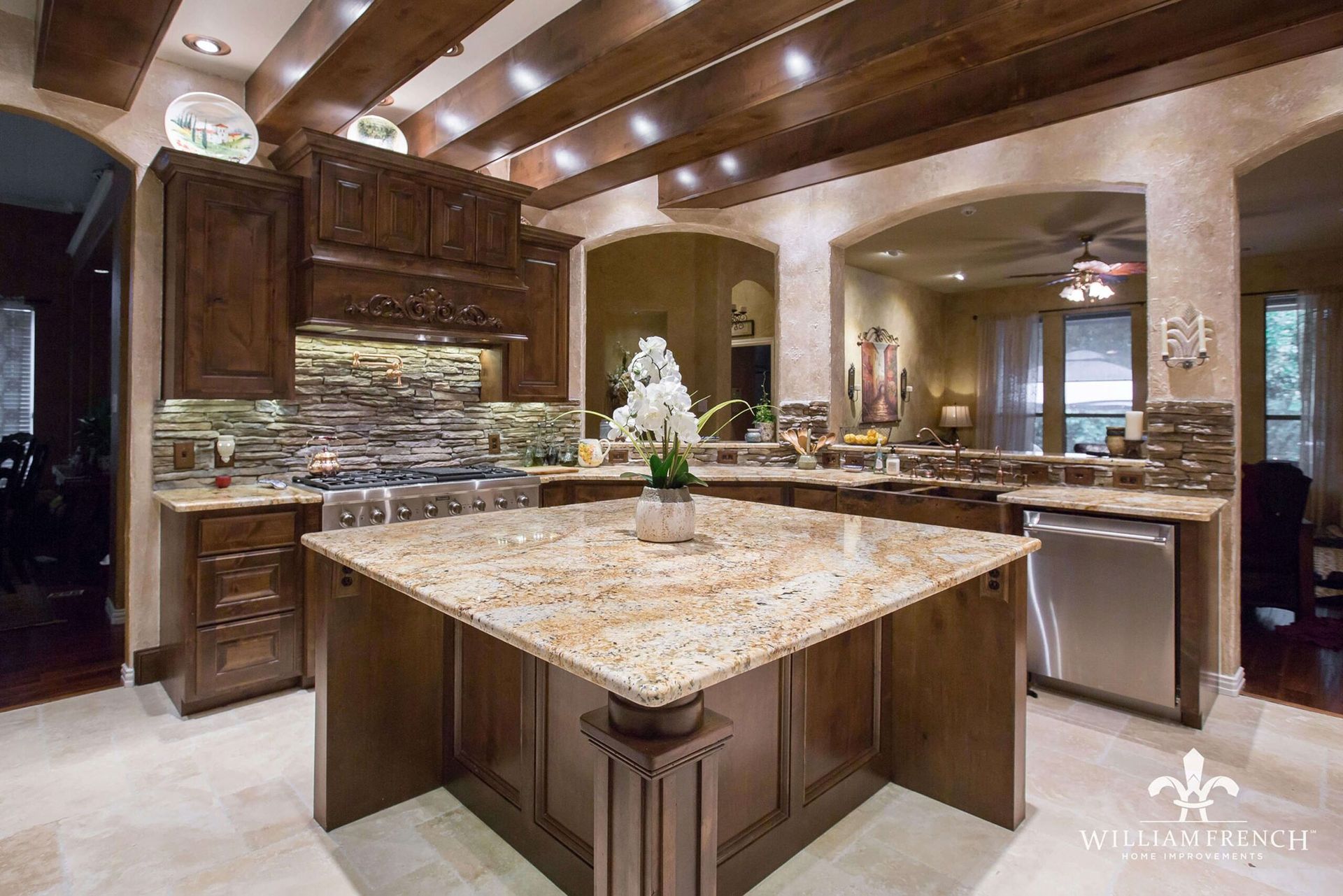 Luxurious kitchen with dark wood cabinets, granite countertops, and island.