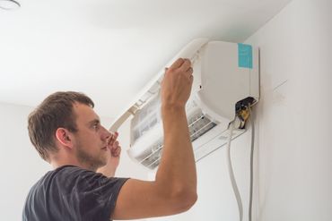 Man installing an air conditioning unit