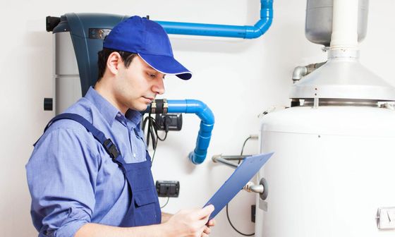 man checking water heaters