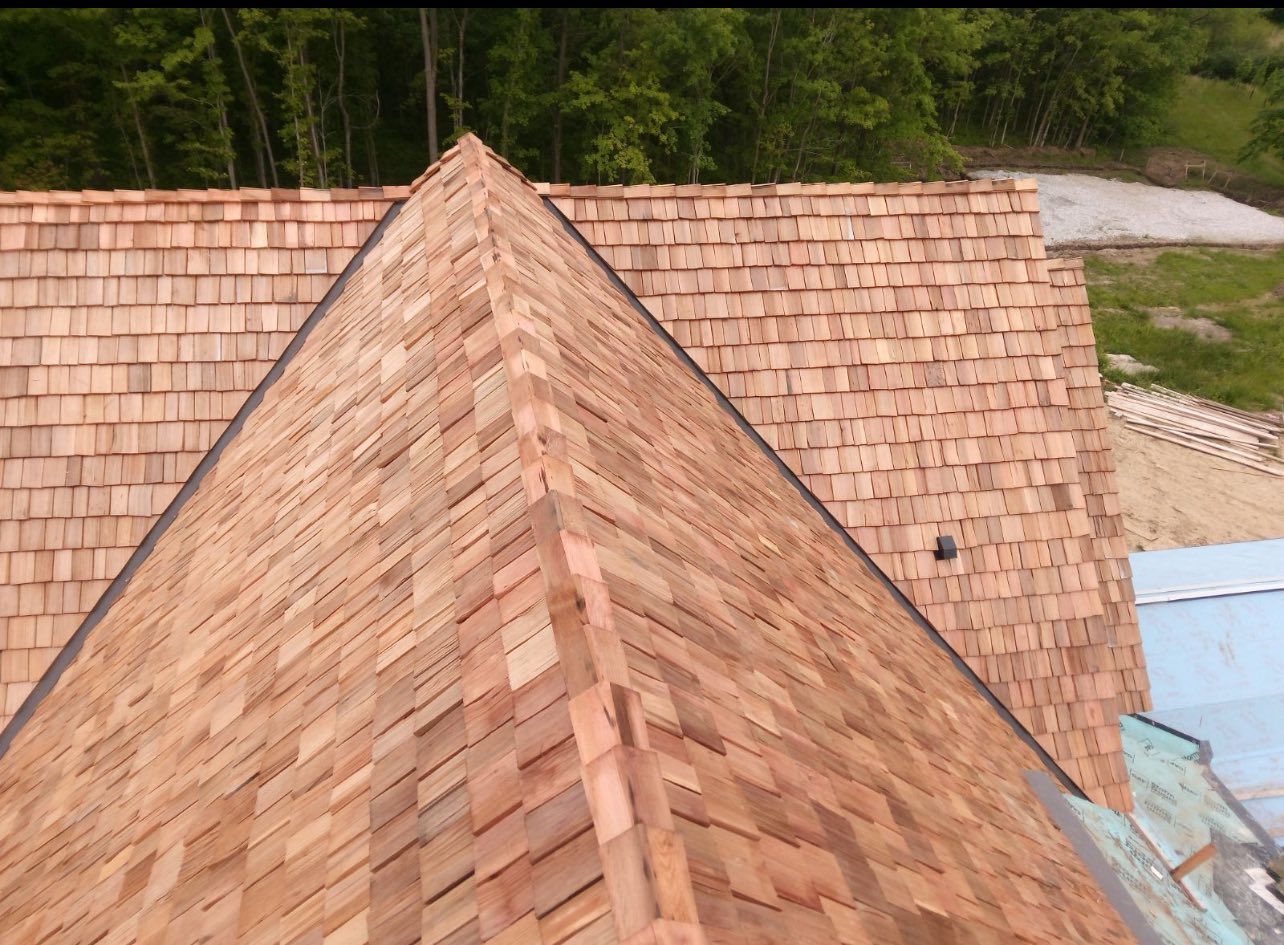 The roof of a house is made of wooden shingles.