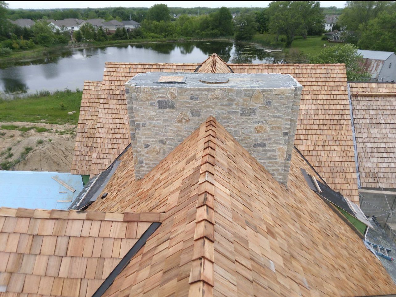 A house with a wooden roof and a stone chimney.