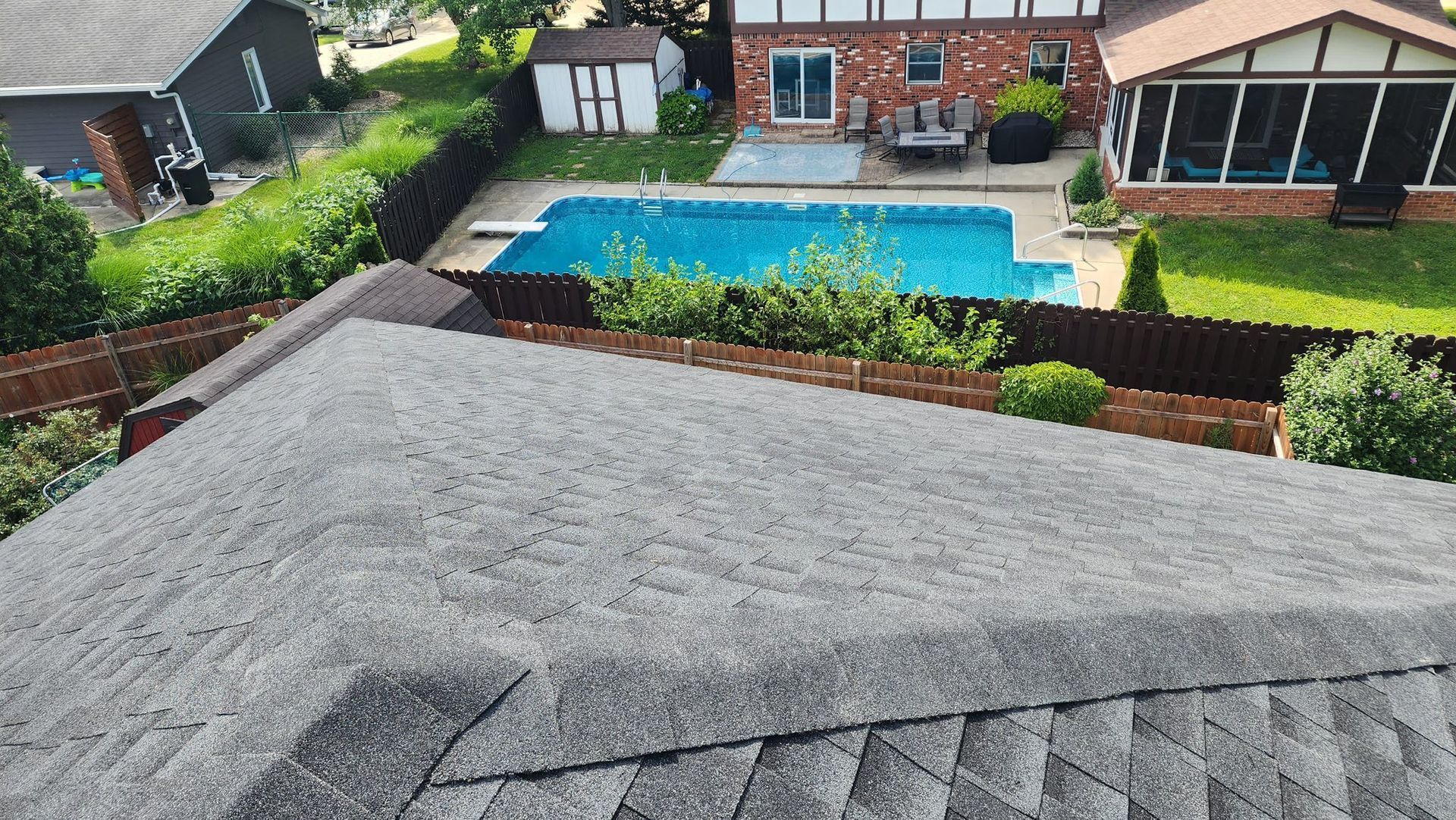 An aerial view of a house with a pool in the backyard.