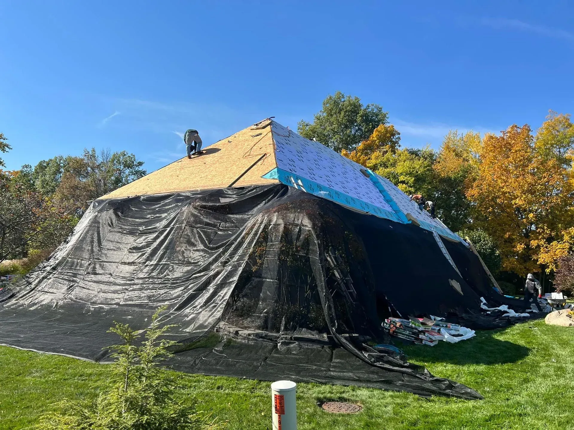 A large tent is sitting on top of a lush green field.
