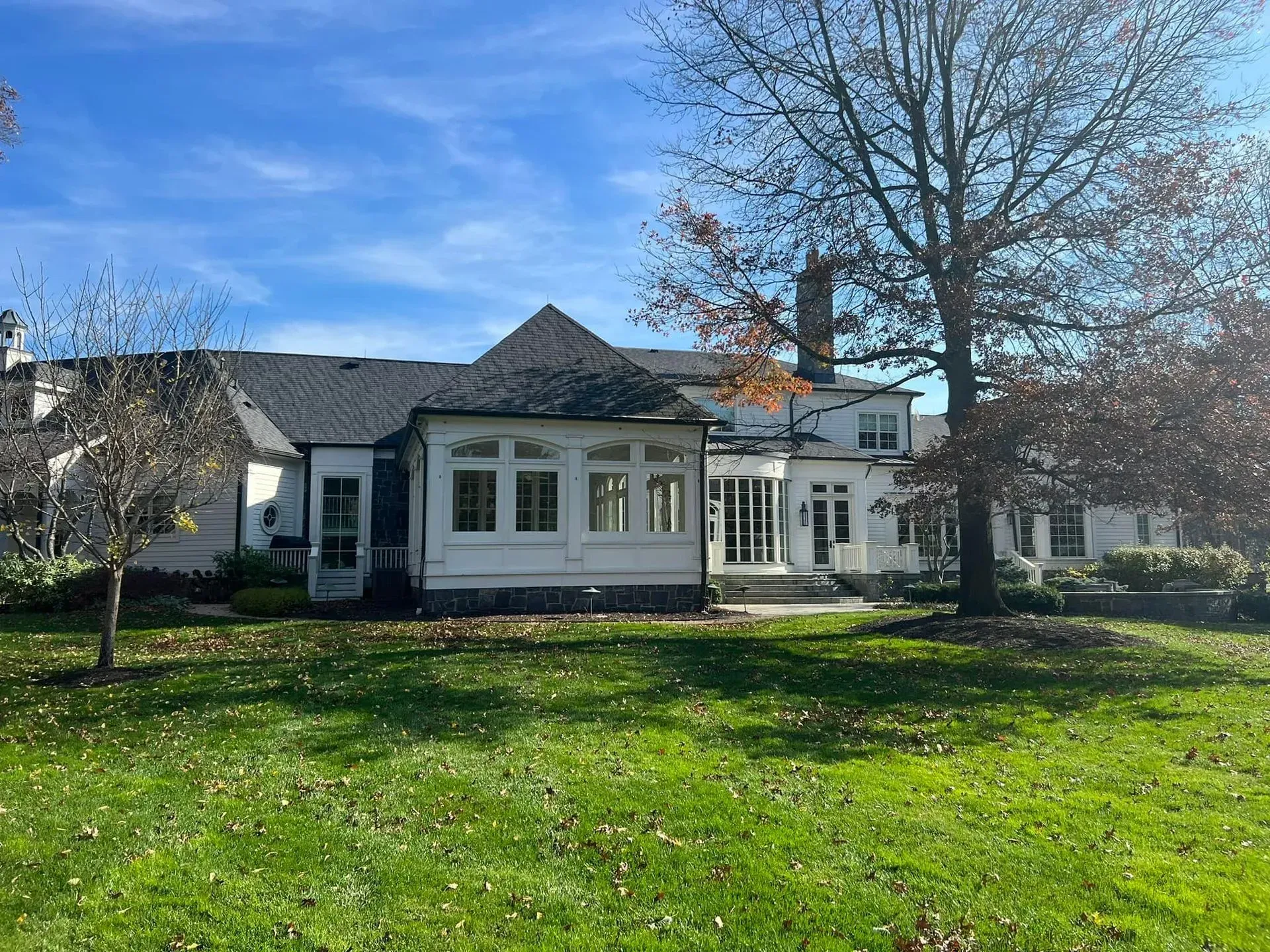 A large white house with a large lawn in front of it.