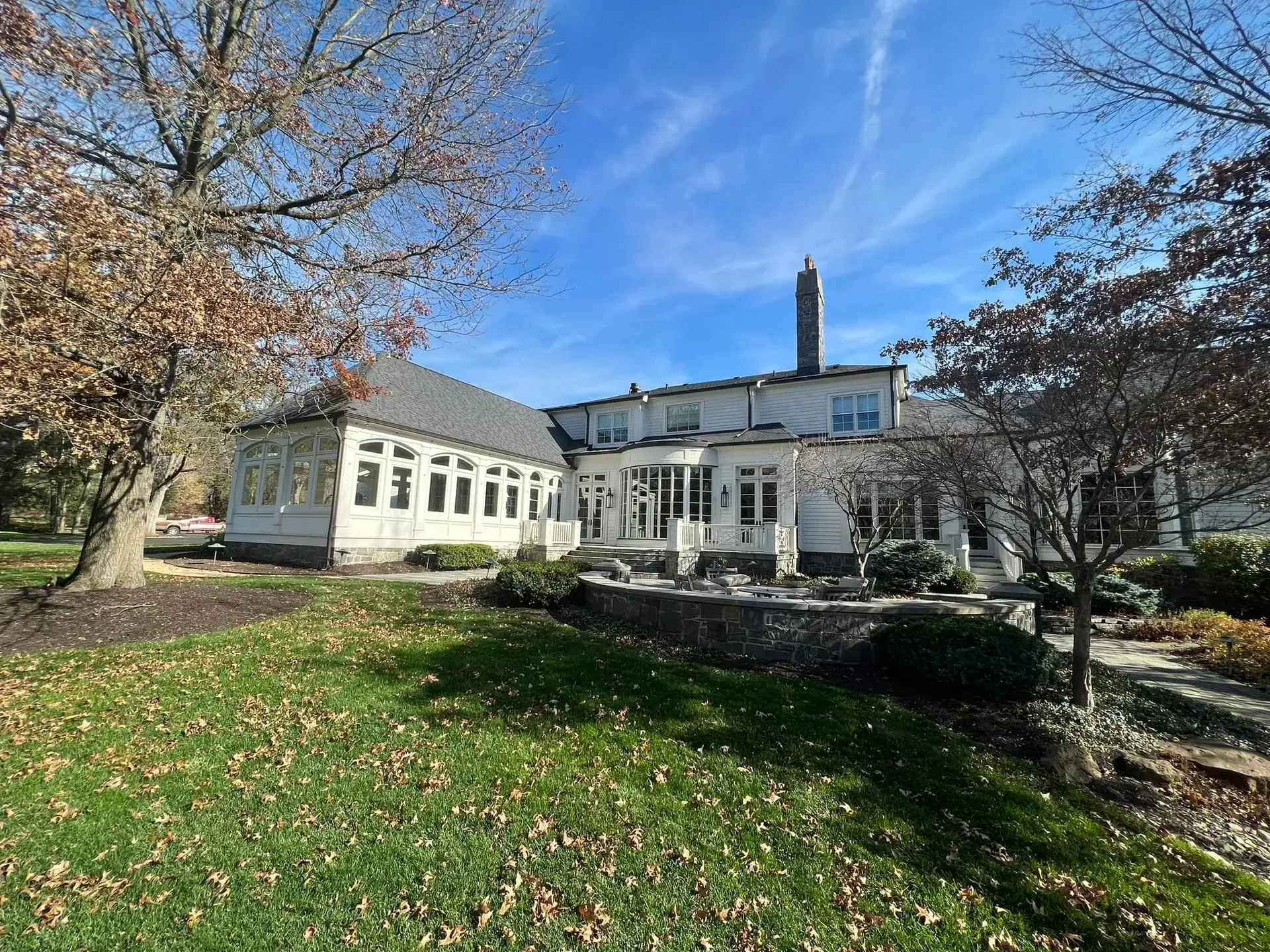 A large white house with a large lawn in front of it.