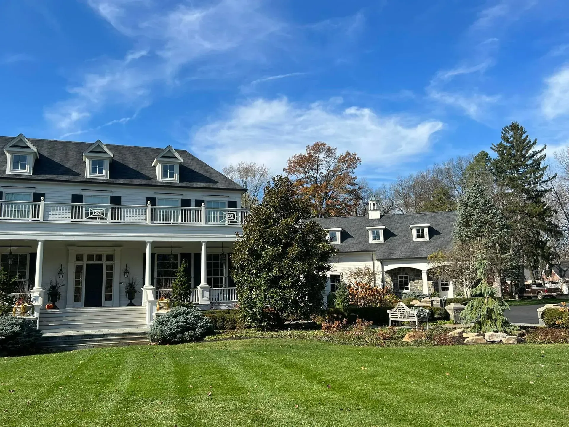 A large white house with a large lawn in front of it.