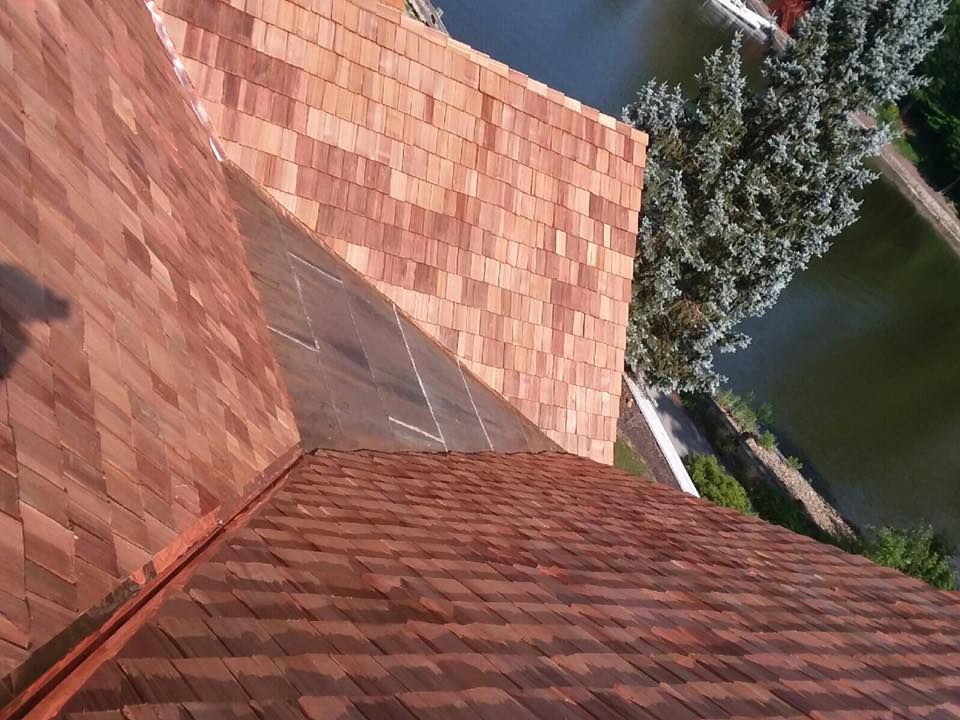 An aerial view of a roof with a river in the background.