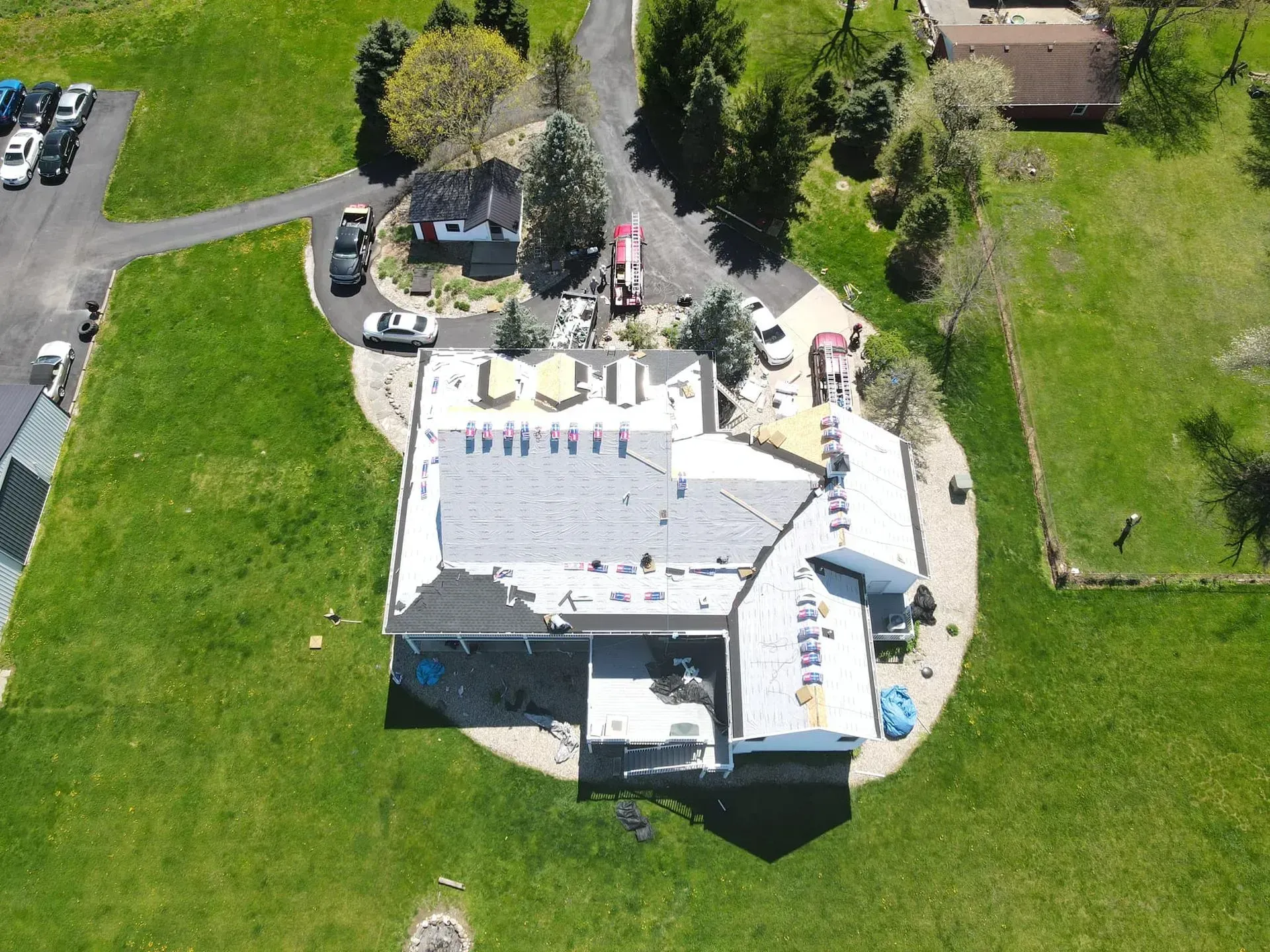An aerial view of a house with a white roof.