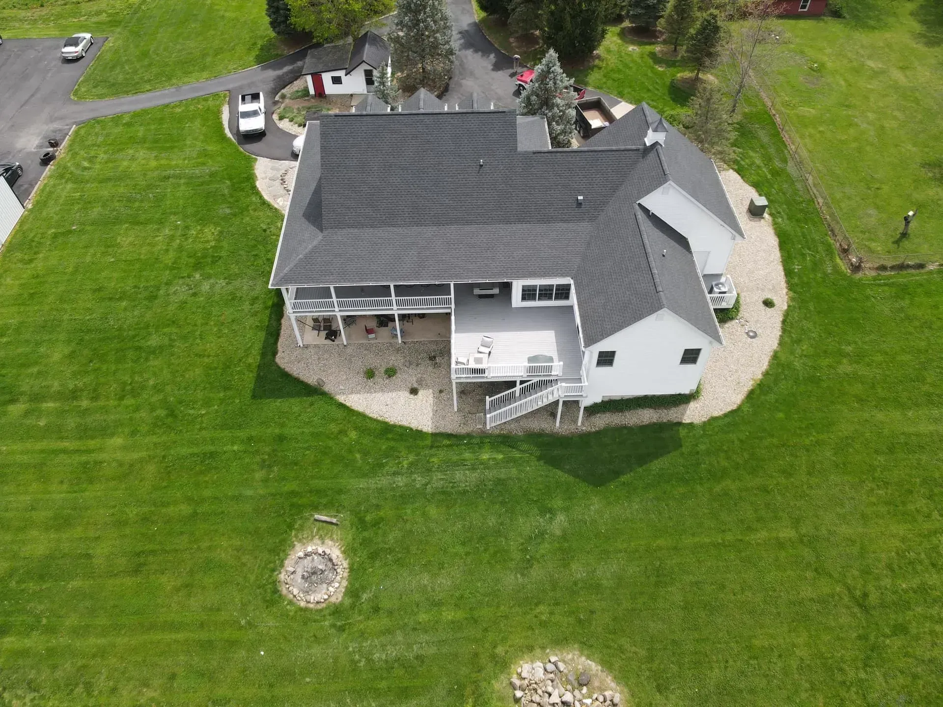 An aerial view of a house with a black roof.