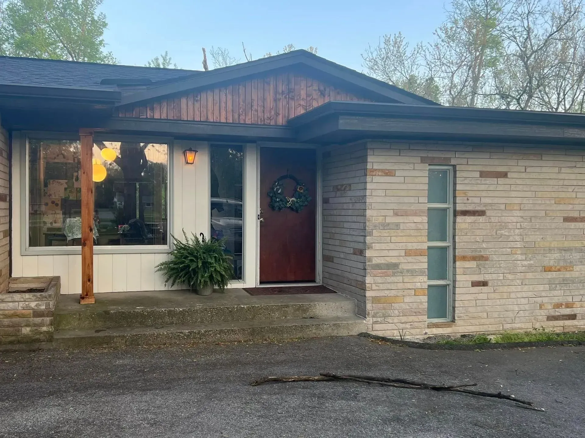 The front of a brick house with a red door.