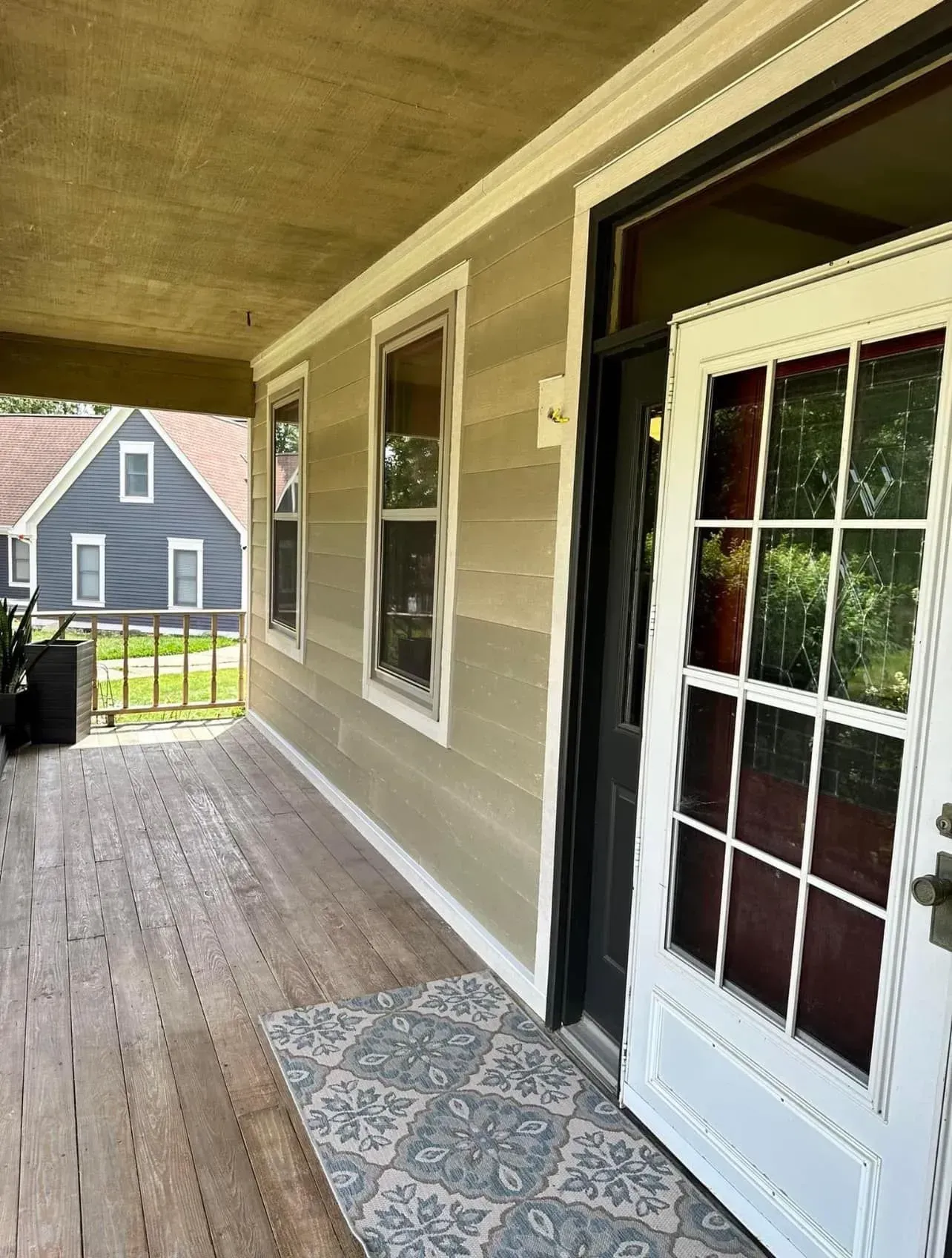 A house with a porch and a white door.