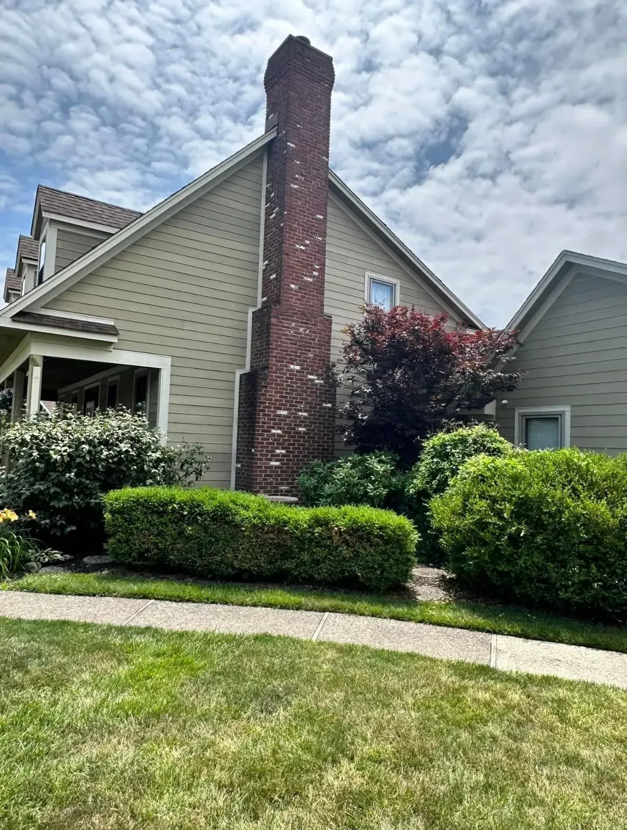 A house with a large chimney on the side of it.