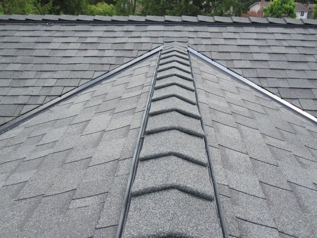 A close up of a roof with a ridge vent on it.
