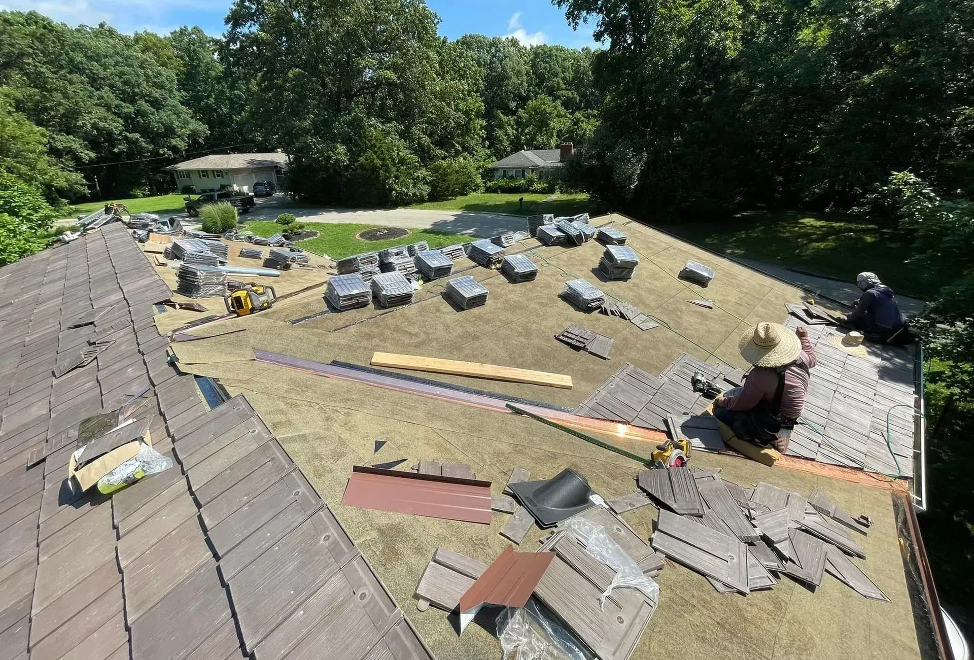 A man is working on the roof of a house.