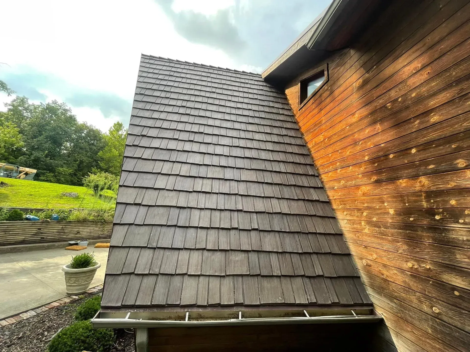 A wooden house with a roof made of wooden shingles.