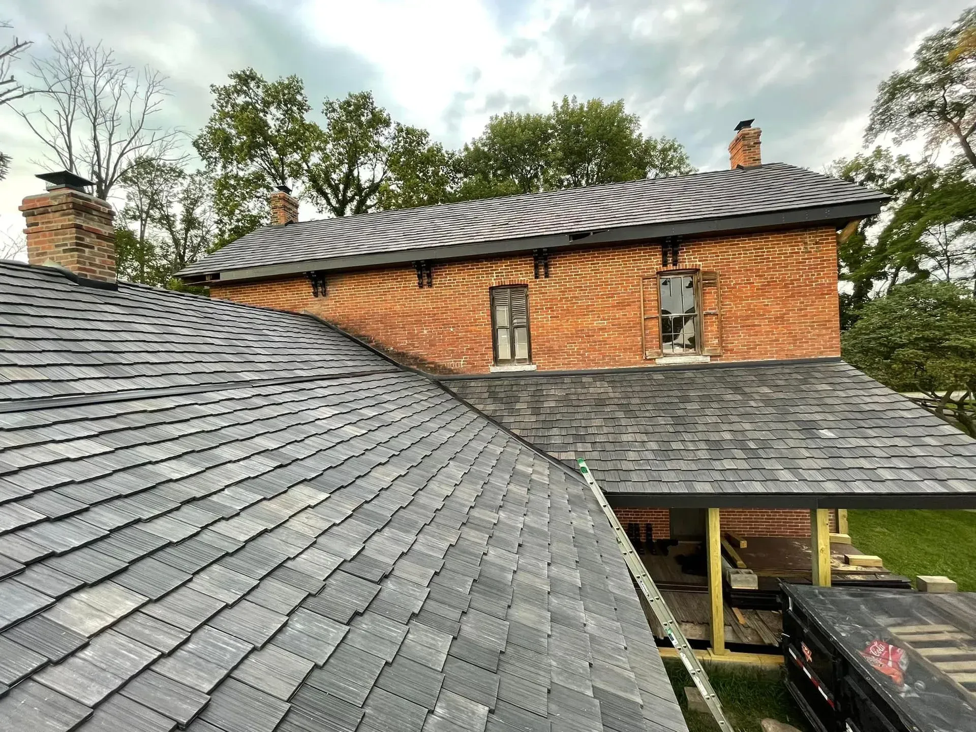 A brick house with a slate roof and chimneys.