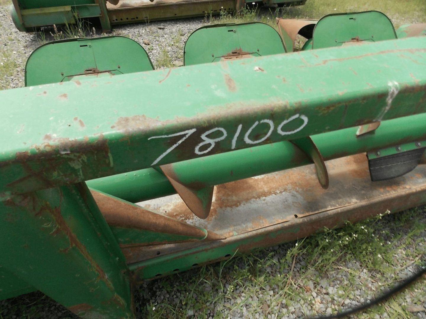 Green agricultural machine with the number 78100 painted on it
