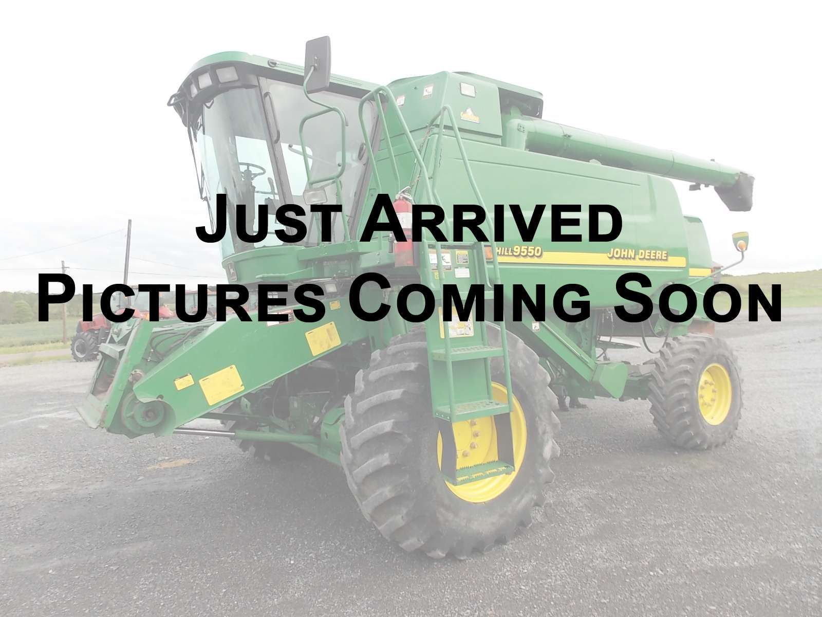 Green tractor with “Just Arrived” and “Pictures Coming Soon” text over a foggy background