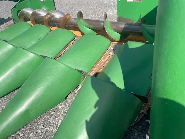 Green inflatable obstacle course with silver balls and a climbing ladder outdoors