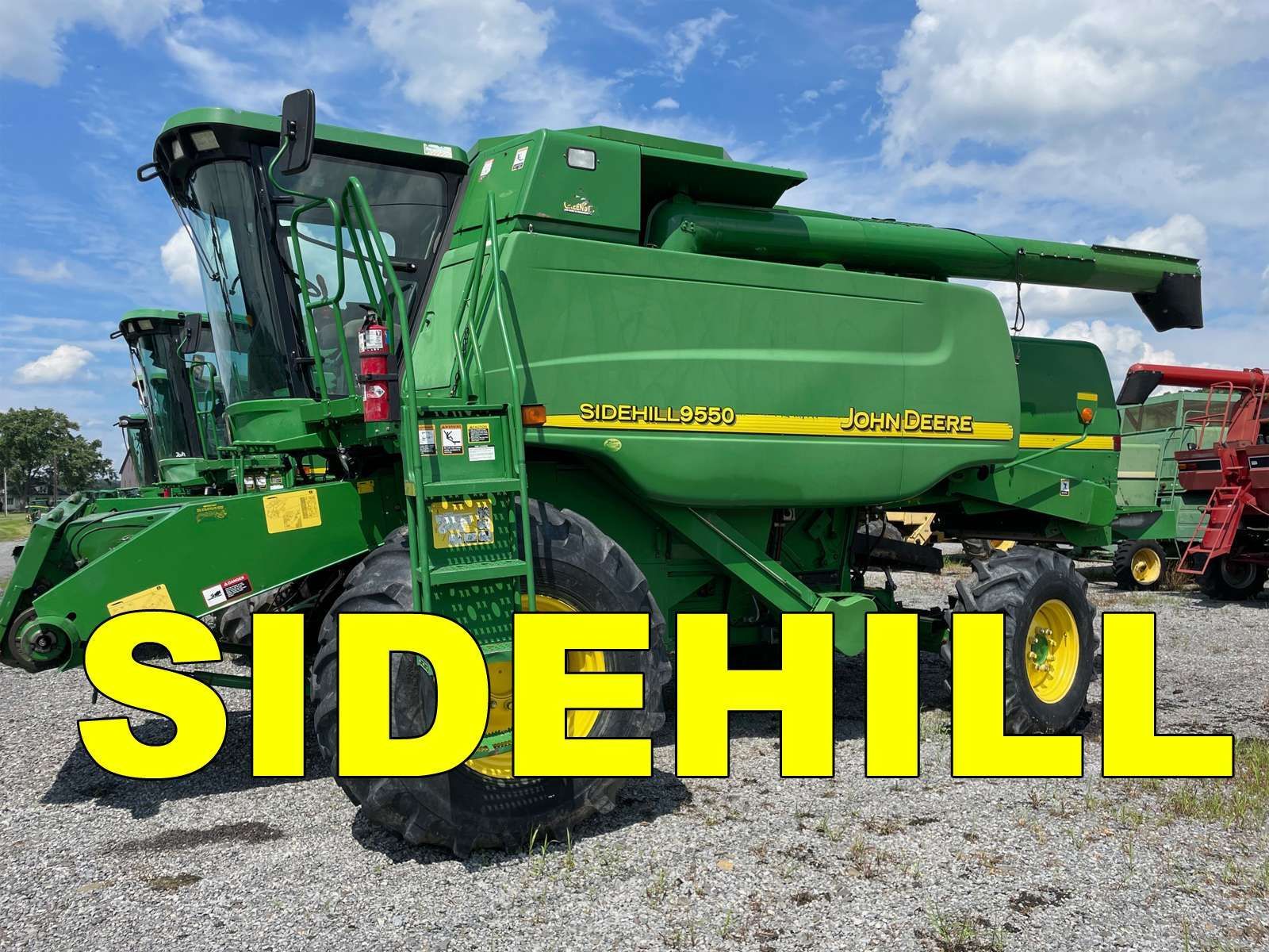 Green combine harvester on a field under blue sky, with bold yellow text “SIDEHILL” across the bottom