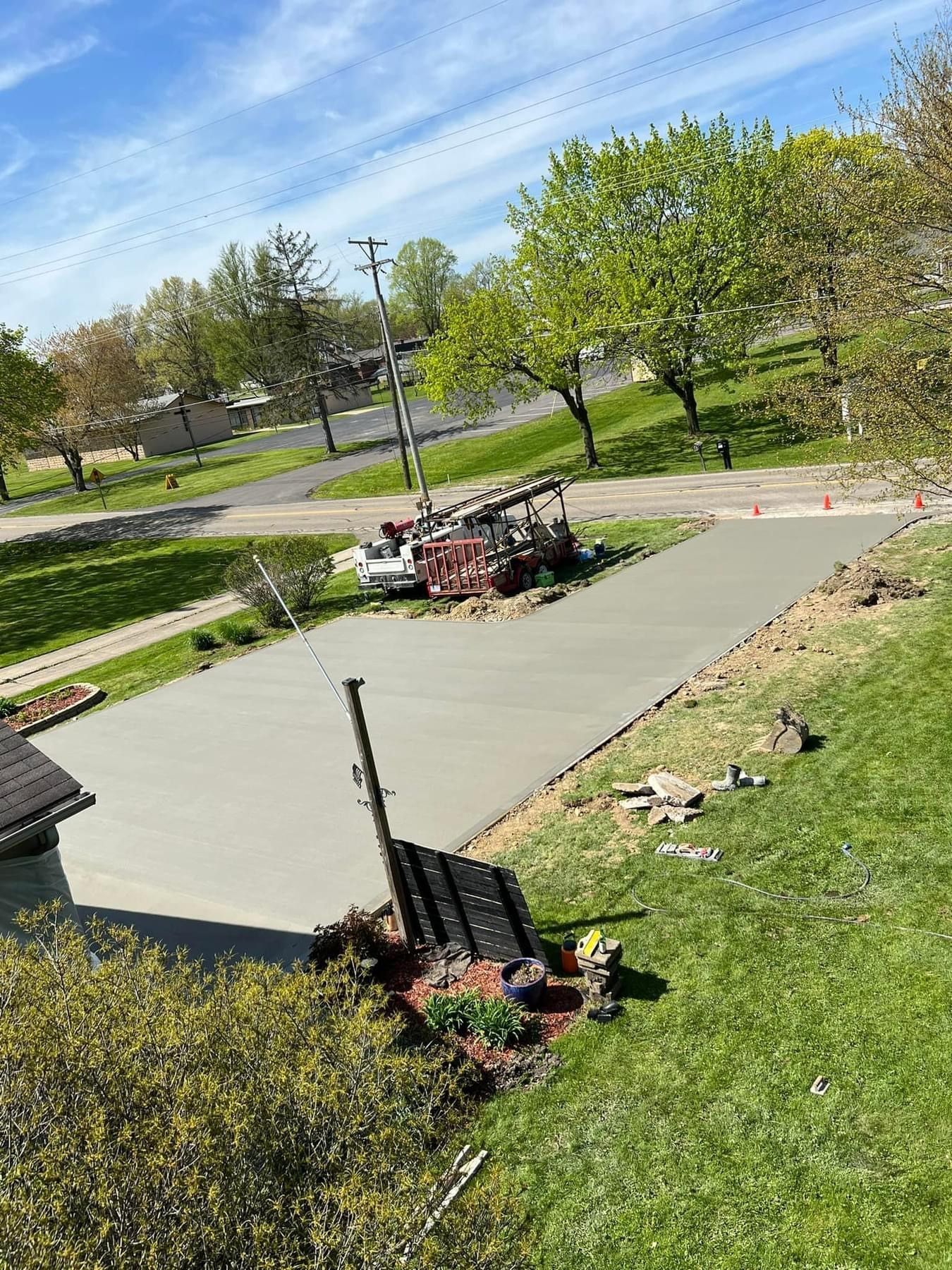 A concrete driveway being built next to a house