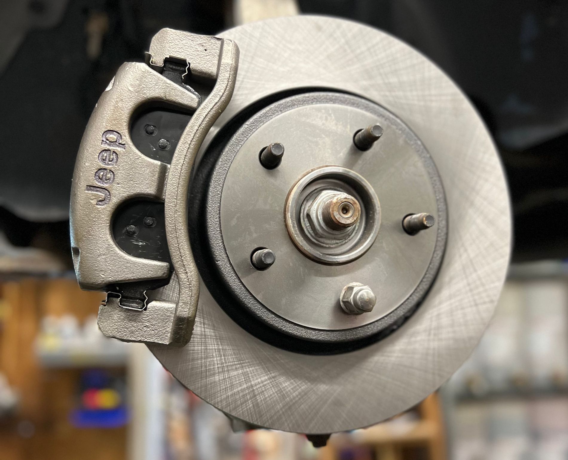 A close up of a brake disc on a jeep