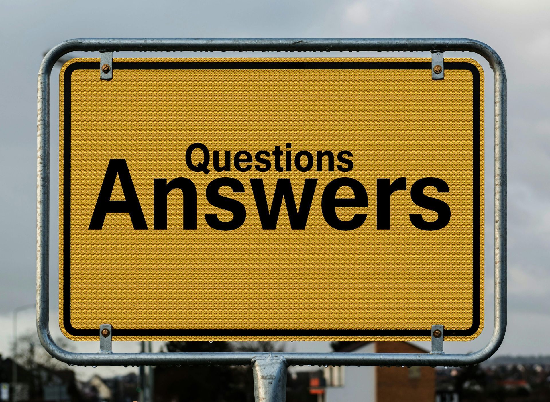 A yellow sign that says questions answers on it