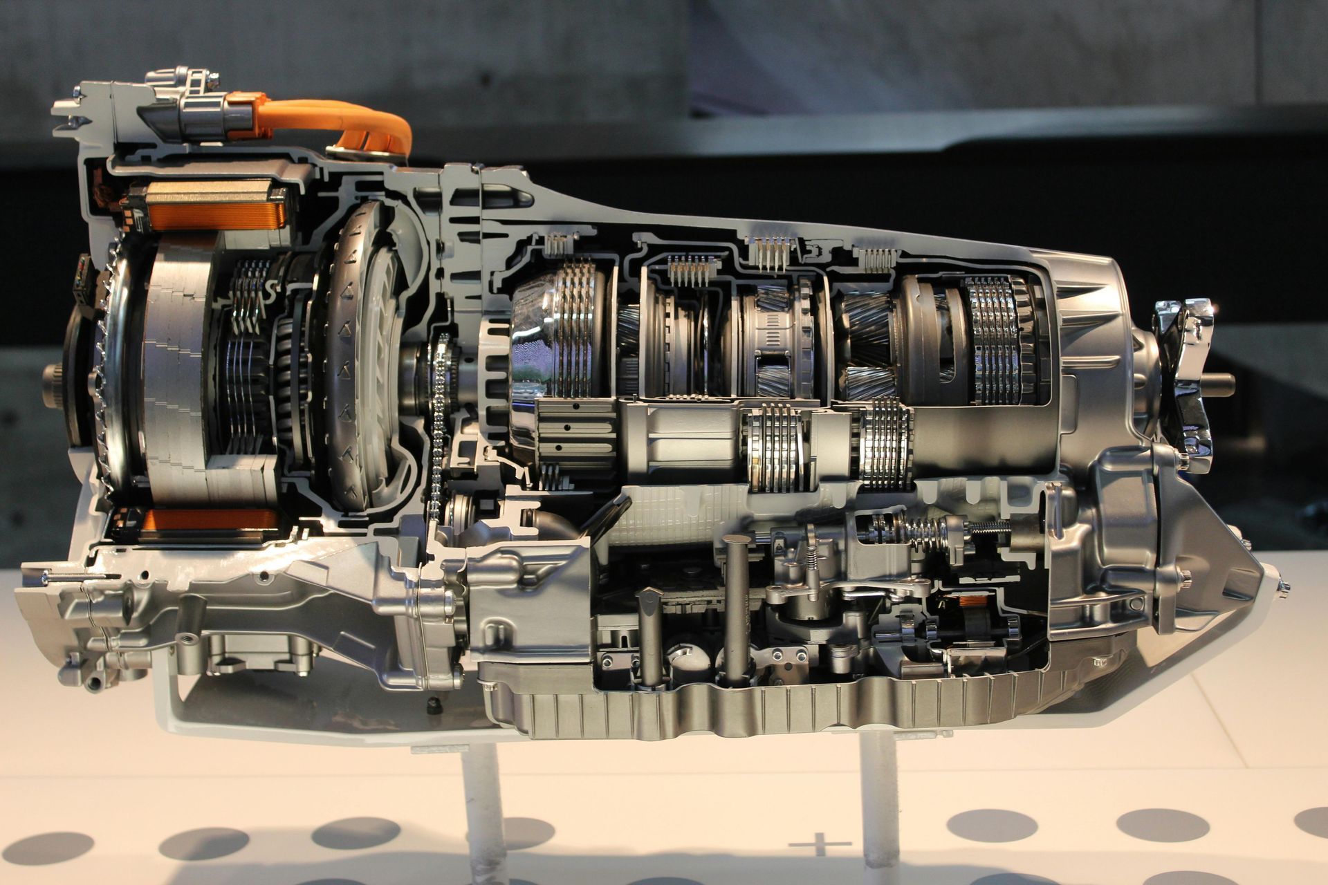 A cut in half model of a car engine on display