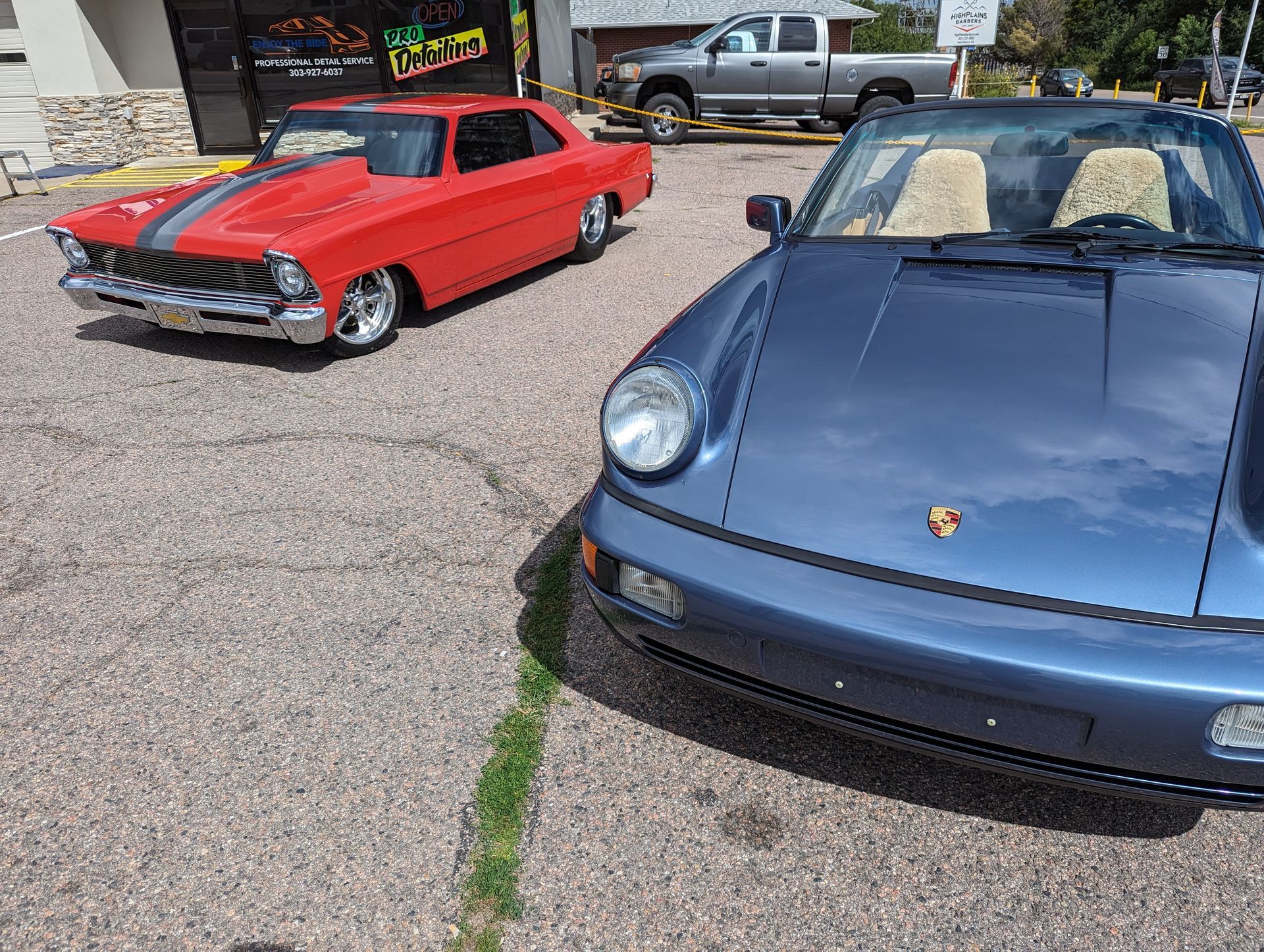 Two cars are parked next to each other in a parking lot.