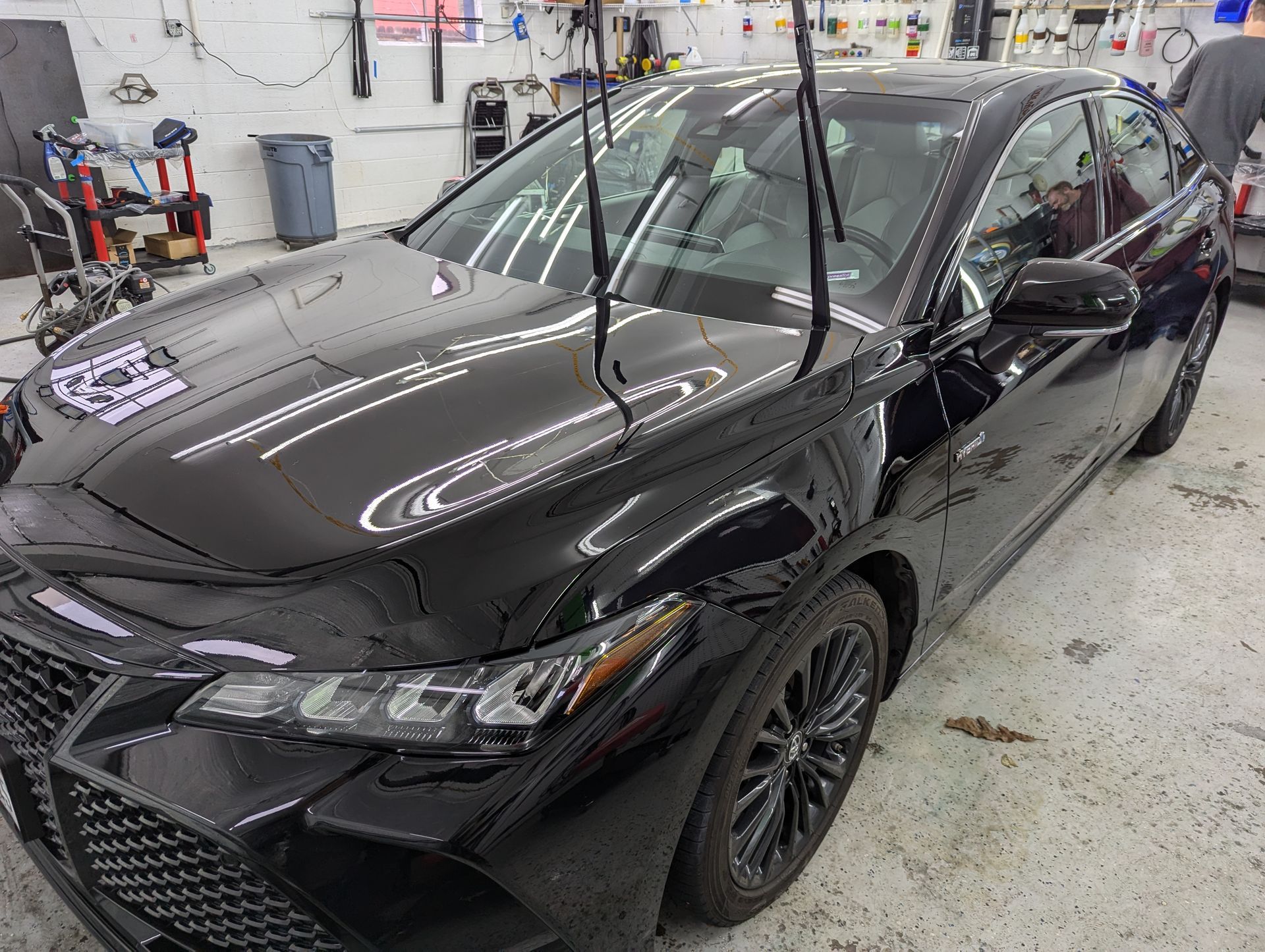 A black car is parked in a garage.