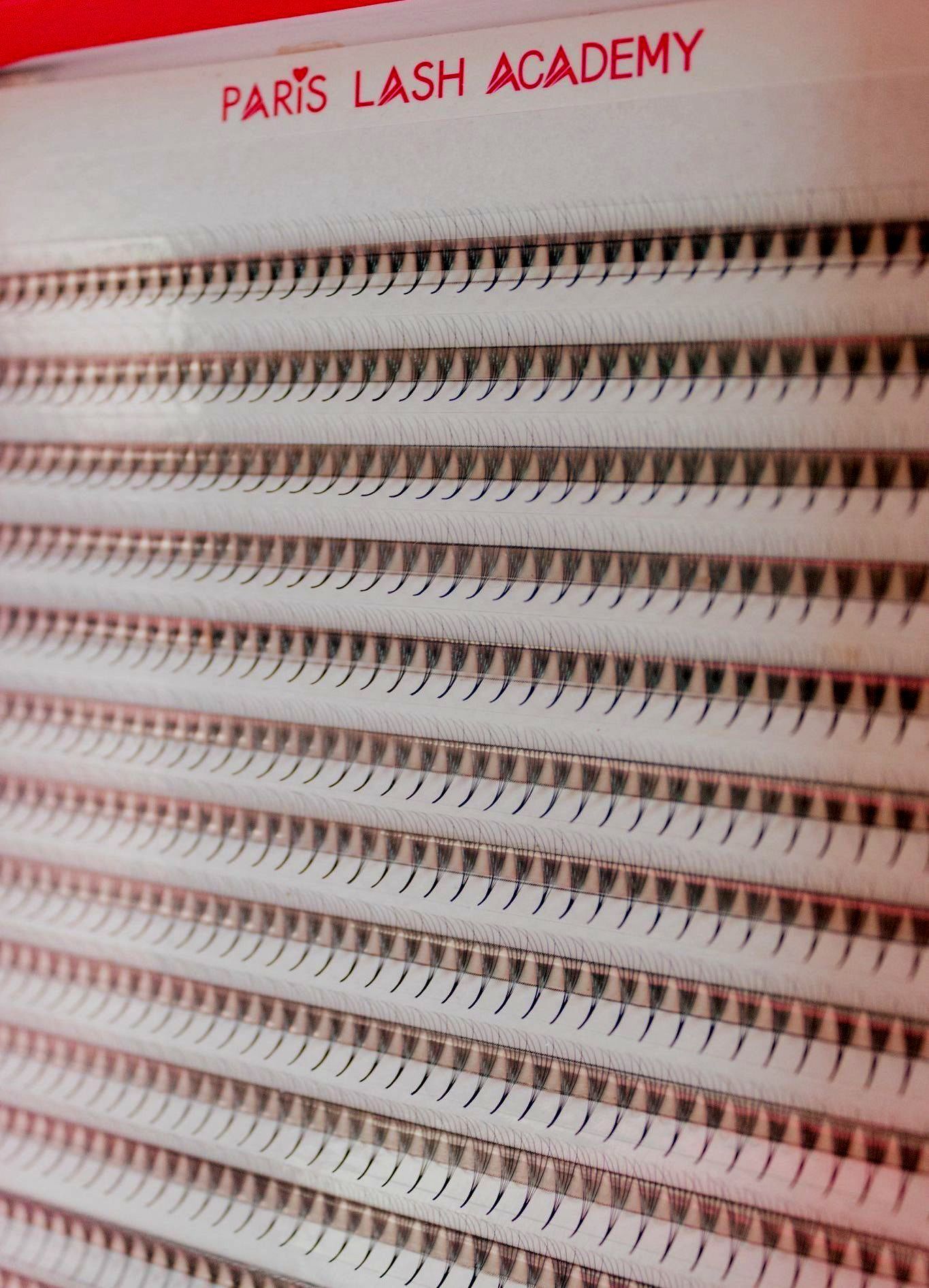 A close up of a paris lash academy display