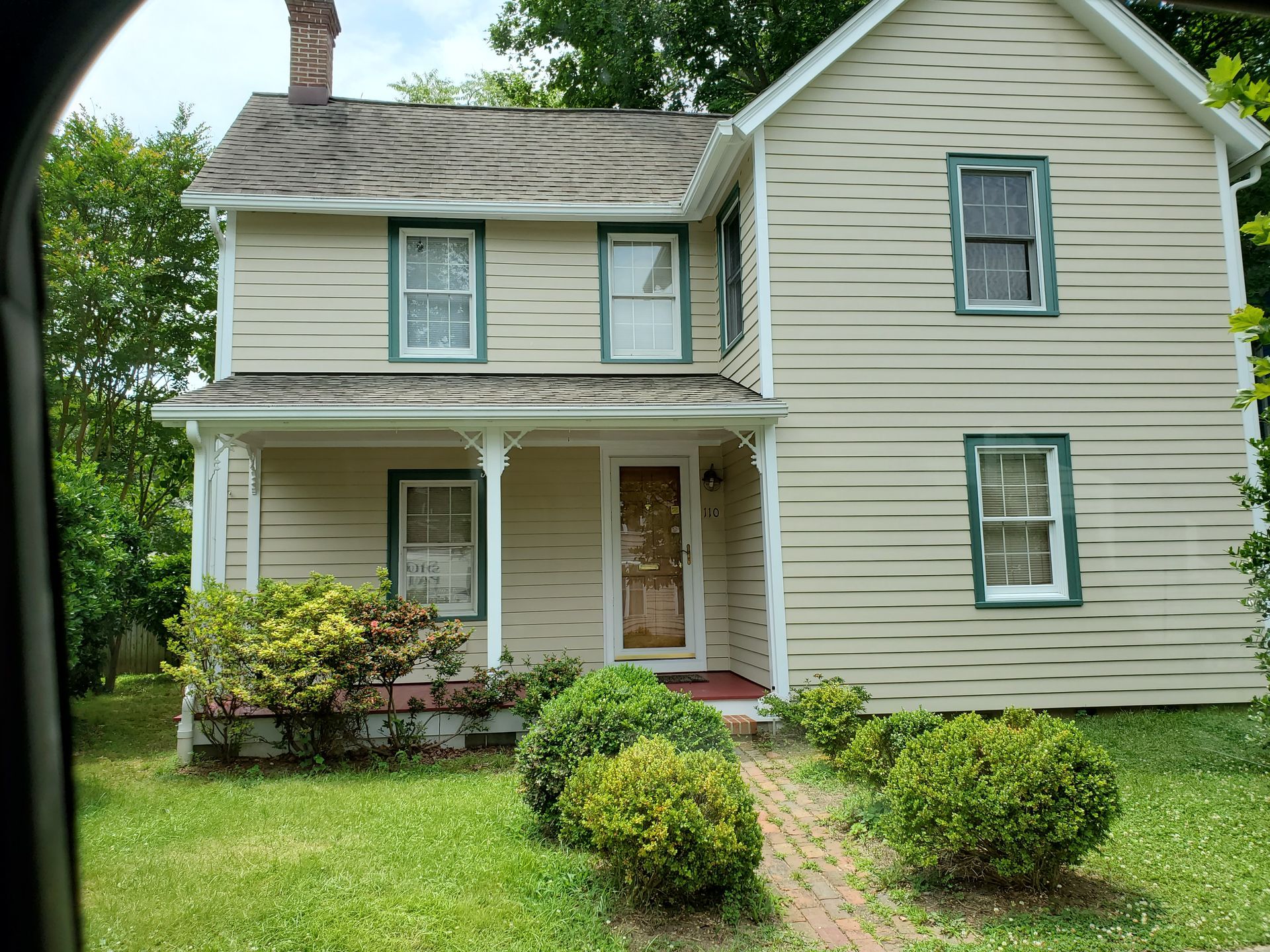 The large house with a professionally applied beige paint job