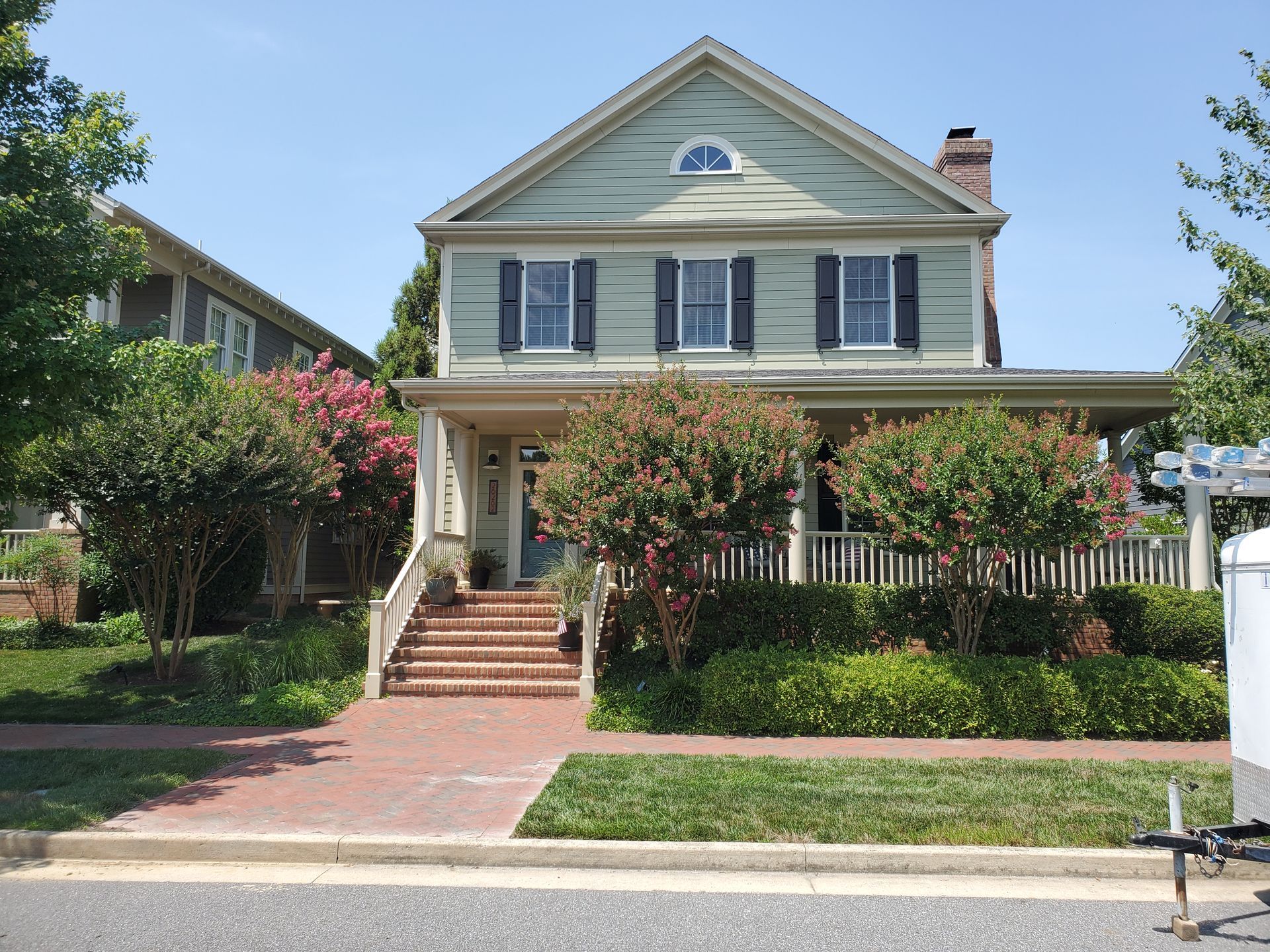 A large house painted with a light green color