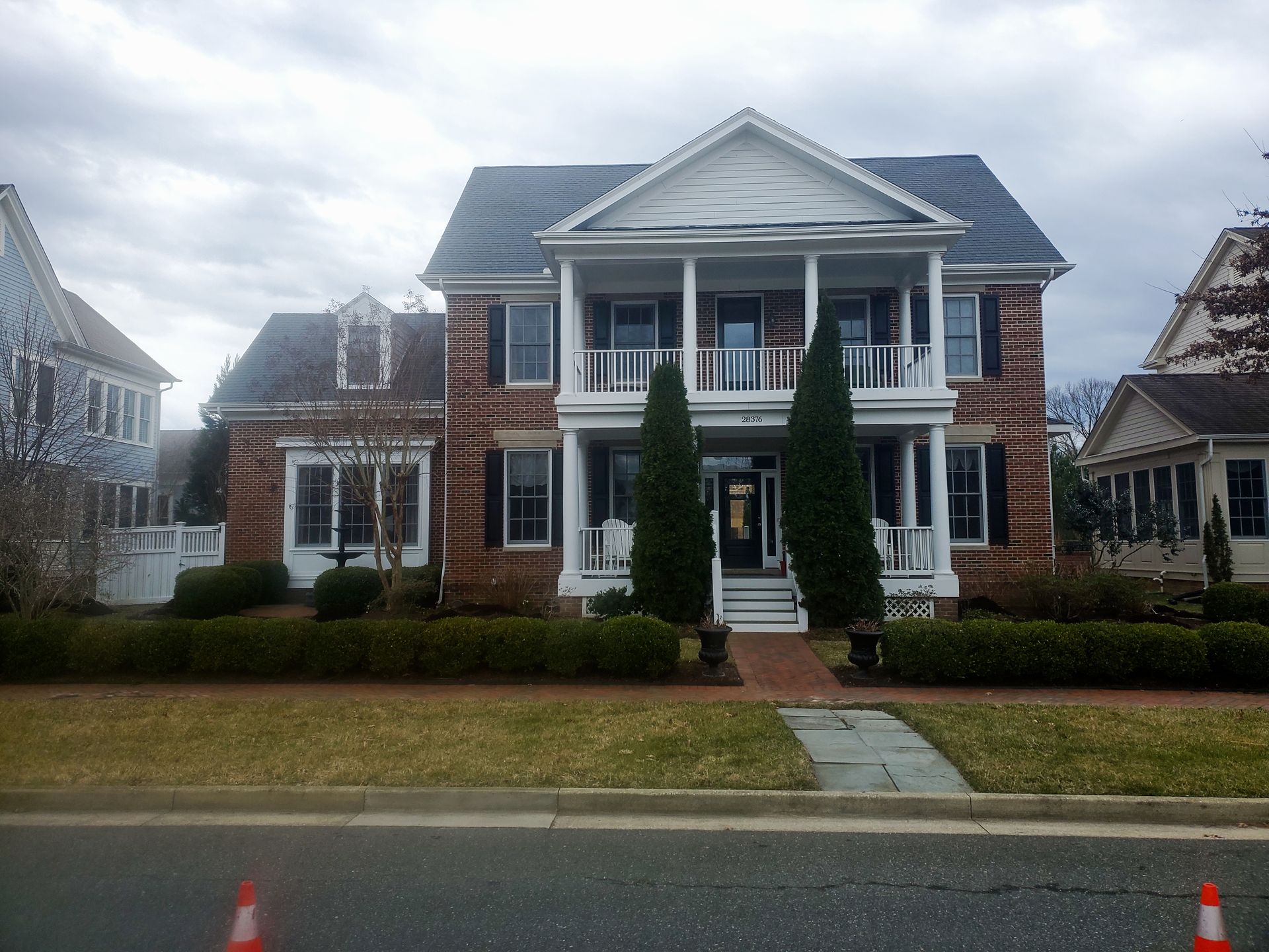 A large house with a blue roof and white trim