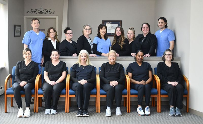 A group of people are posing for a picture in a waiting room.